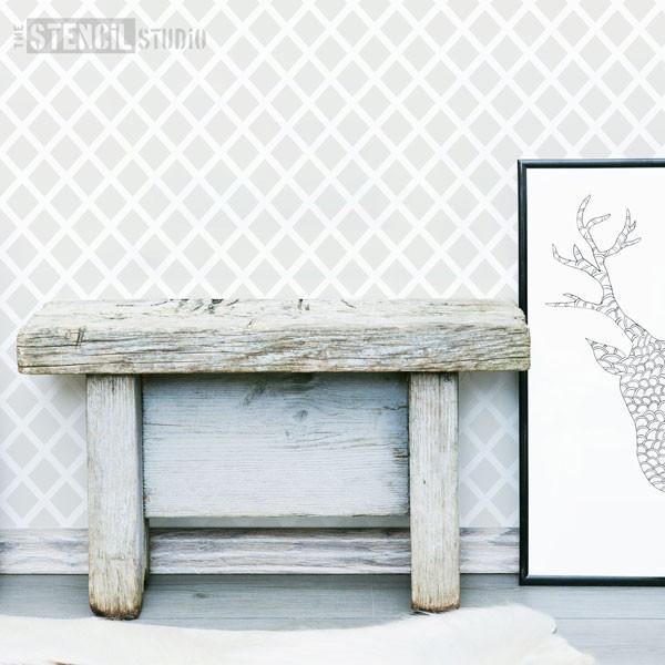 Diamonds Forever stencil featuring the S size stencil in grey in Scandi style interior with stag head framed print and wooden bench